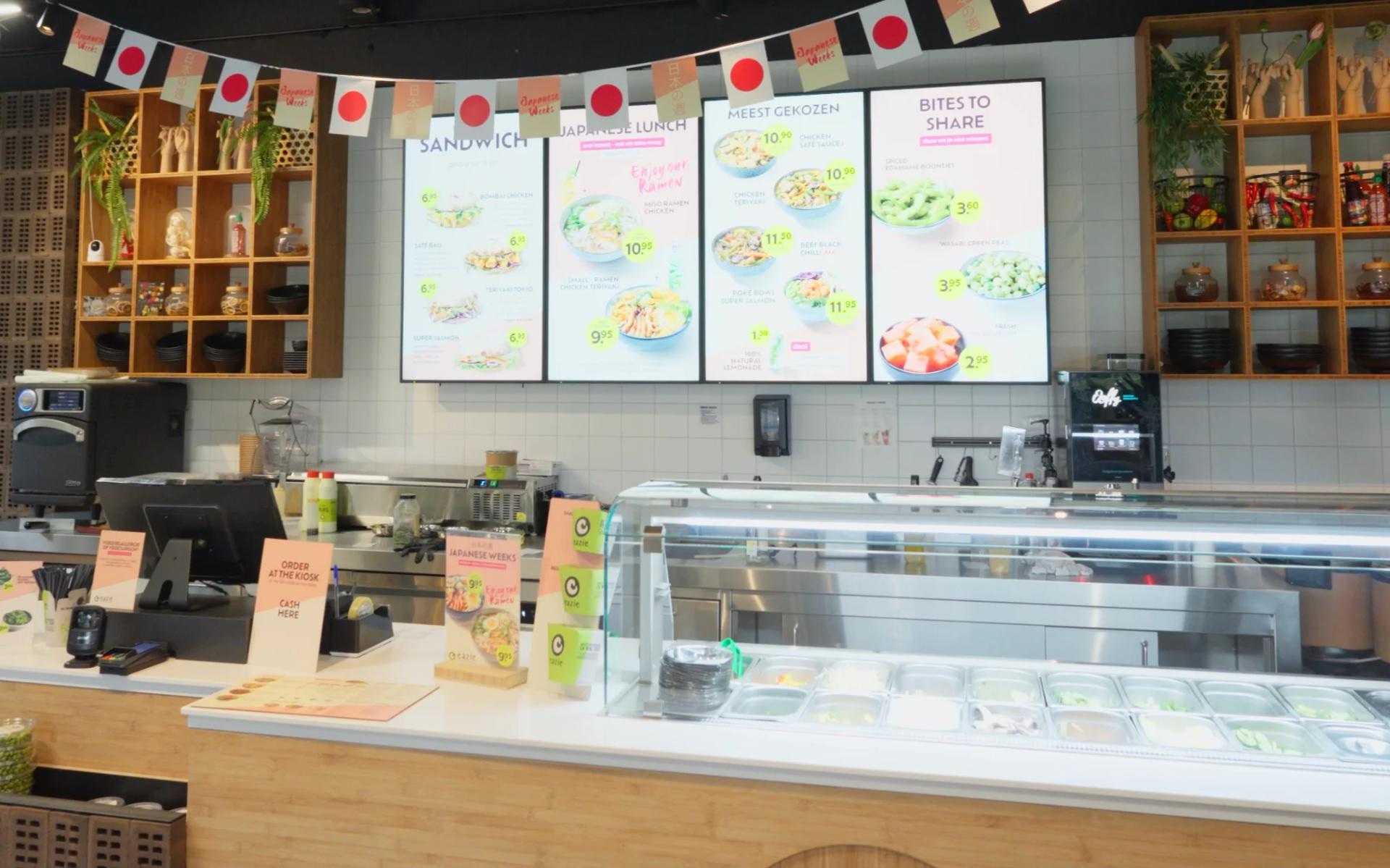 Jamezz hospitality kiosk revenue growth - Modern bar with digital menu screens and self-service kiosk for higher revenue